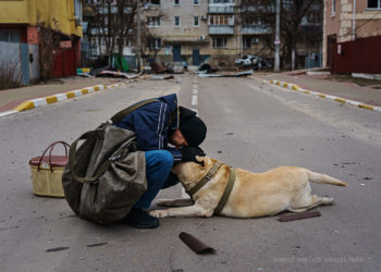 Foto sa 1 mijë fjalë, burri qetëson qenin e tmerruar nga bombardimet ruse