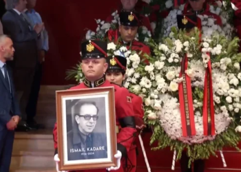 Me duartrokitje dhe karafilë të bardhë, Kadare niset për në banesën e fundit