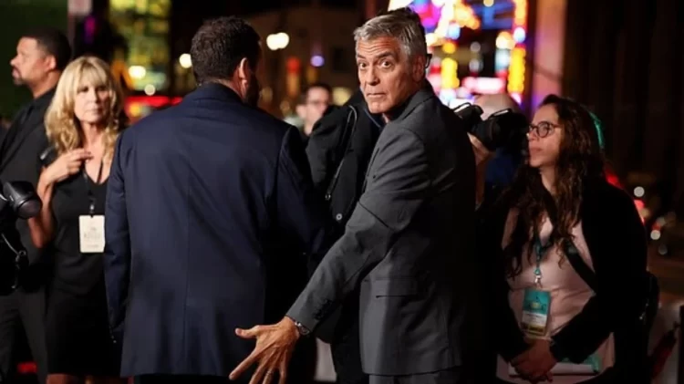 Momente gazmore në Hollywood: George Clooney vendos me shaka dorën mbi të pasmet e Adam Sandler